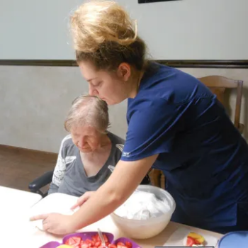 Senior care professional assisting elderly