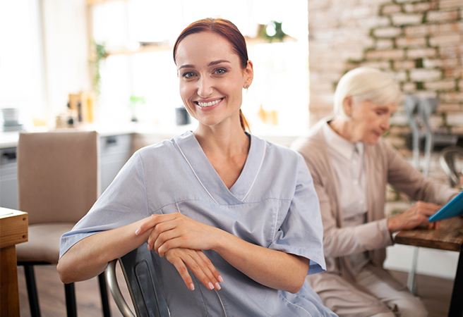 Smiling caregiver with senior woman