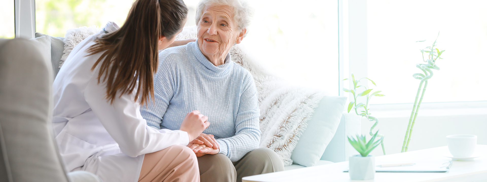 Caregiver comforting elderly woman compassionate